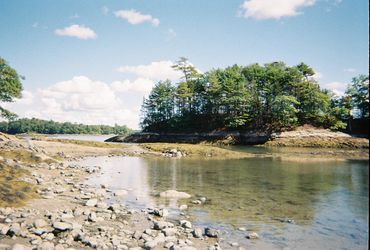 Photograph of a waterfront landscape with a small island