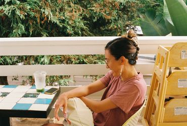 Profile of girl sitting at tiled tabletop