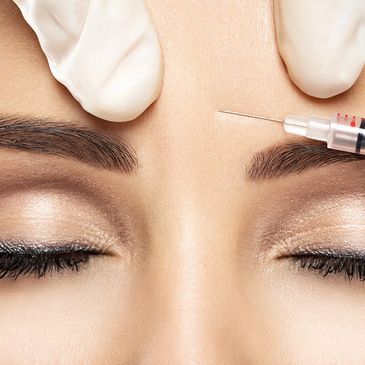 close up of botox needle in between eyes. 