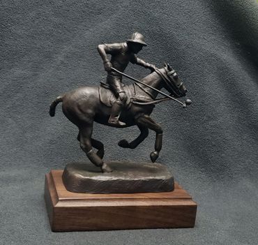 Indio Polo Trophy Bronze Polo Pony and rider juggling the ball with his mallet while galloping.