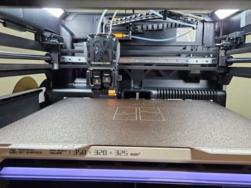 Interior view of a Bambu Lab 3D printer with detailed components visible.