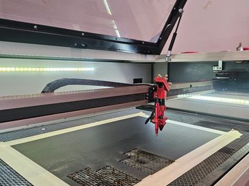 A laser cutter engraving material inside the machine.