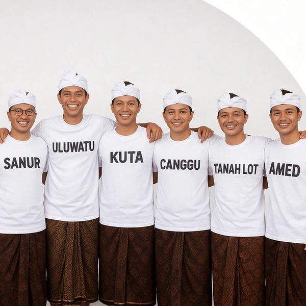 Six men wearing white shirts with names of Bali locations and traditional sarongs.
