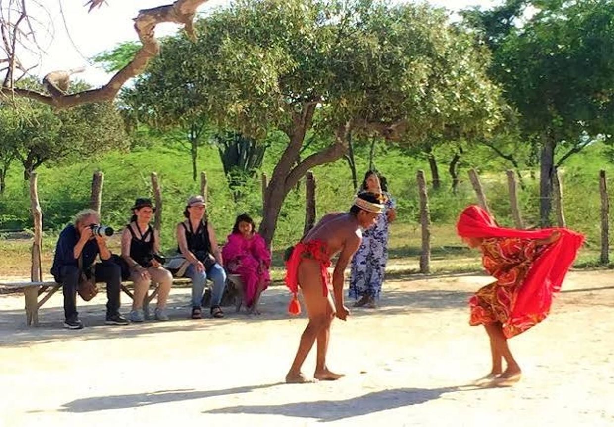 Danza tradicional al aire libre con espectadores observando.
