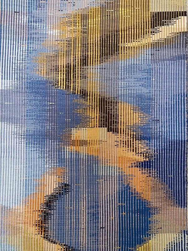 Abstract woven textile art with blue, yellow, and beige tones.