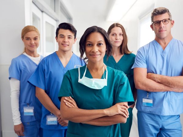 Portrait Of Multi-Cultural Medical Team Standing In Hospital Corridor