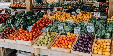 Fresh vegetables and fruits displayed at a market stall.