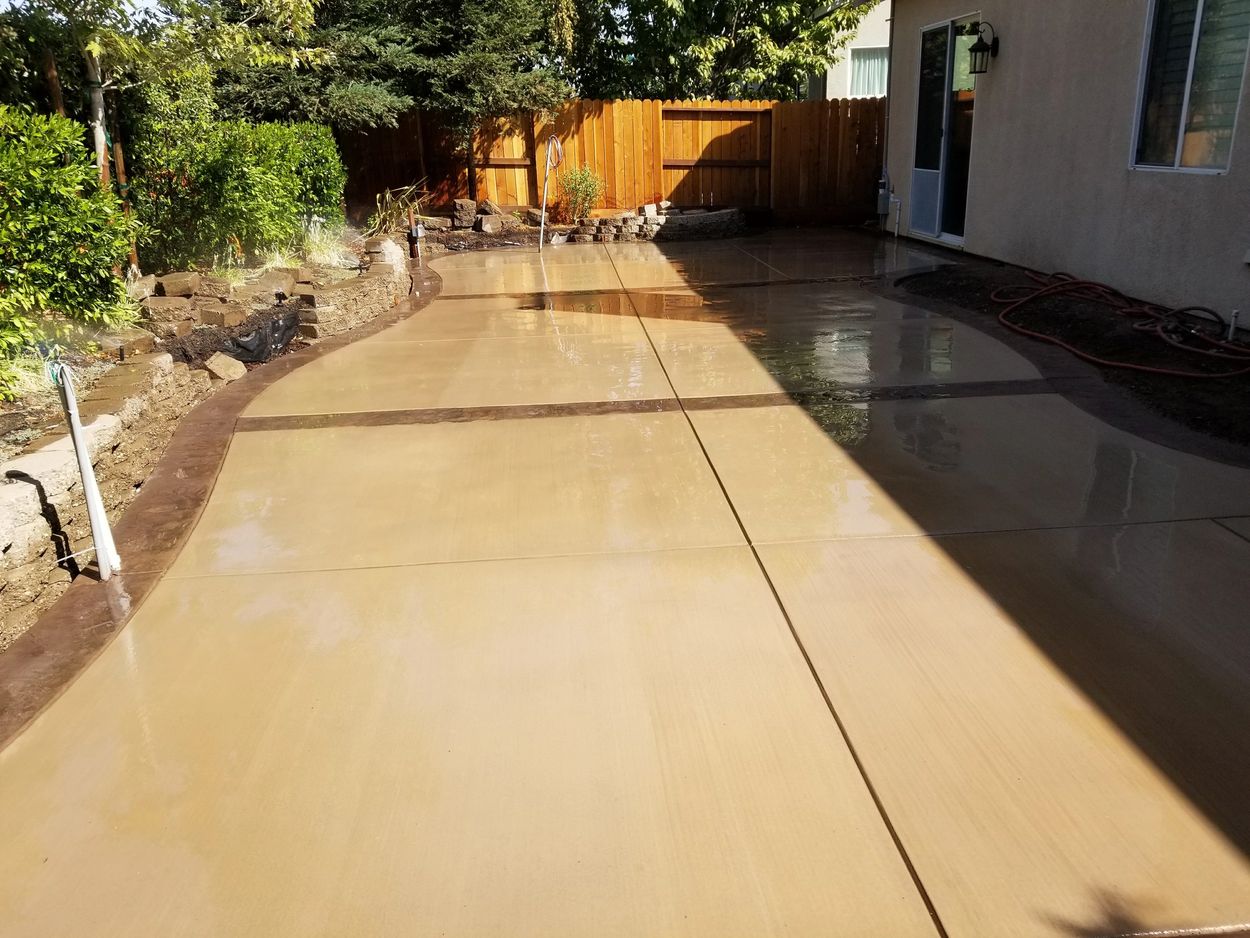 Patio with Stamped banding and broom finish. This installation was performed over two separate pours