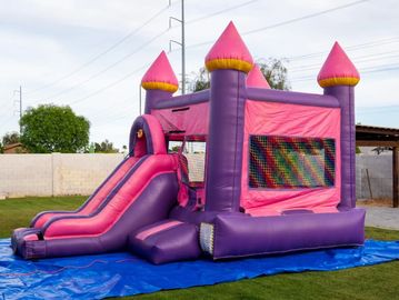 Pink and purple inflatable bounce house and water slide for kids, teens and adults.