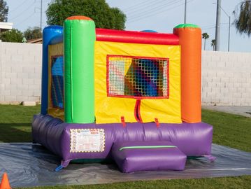 Small rainbow bounce house for kids.