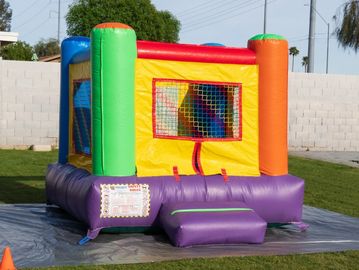 Small rainbow bounce house for kids.