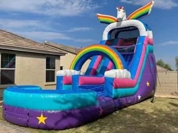 Unicorn rainbow glittery inflatable water slide for kids.
