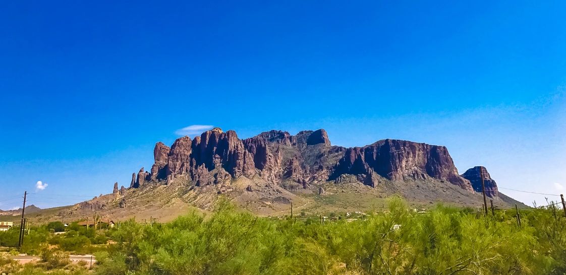 Vast desert mountain under a clear blue sky.