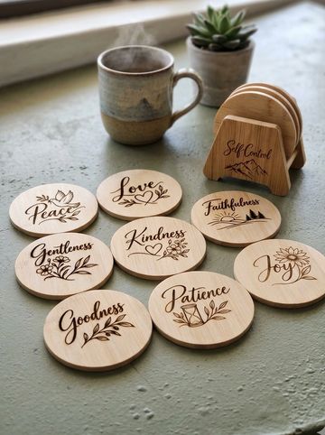 Wooden coasters with positive words and a steaming cup of coffee.