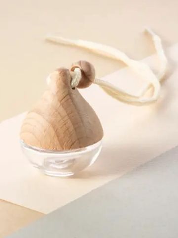 Wooden spinning top with a string on a light surface.