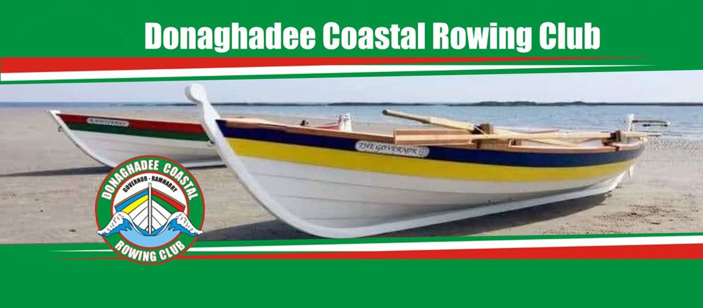 Traditional rowing boats on a beach with Donaghadee Coastal Rowing Club branding.