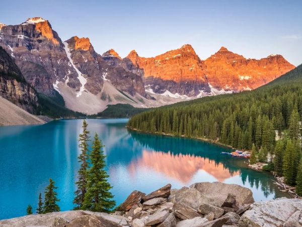 A scenic landscape with mountains, a lake, and a clear sky, showcasing nature's beauty.