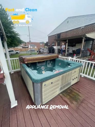 Outdoor hot tub on wooden deck with appliance removal ad.