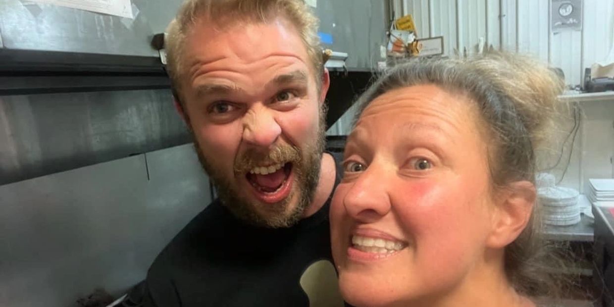 Two people making funny faces in a kitchen setting.