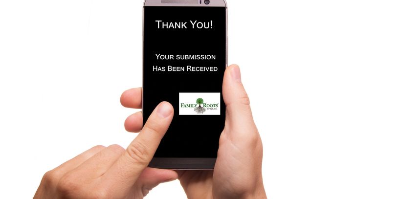 Person holding phone with 'Thank You' submission received message.