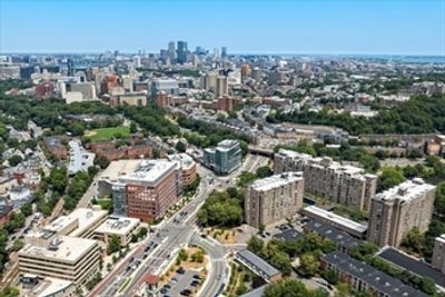 A cityscape with buildings and roads under clear blue sky.