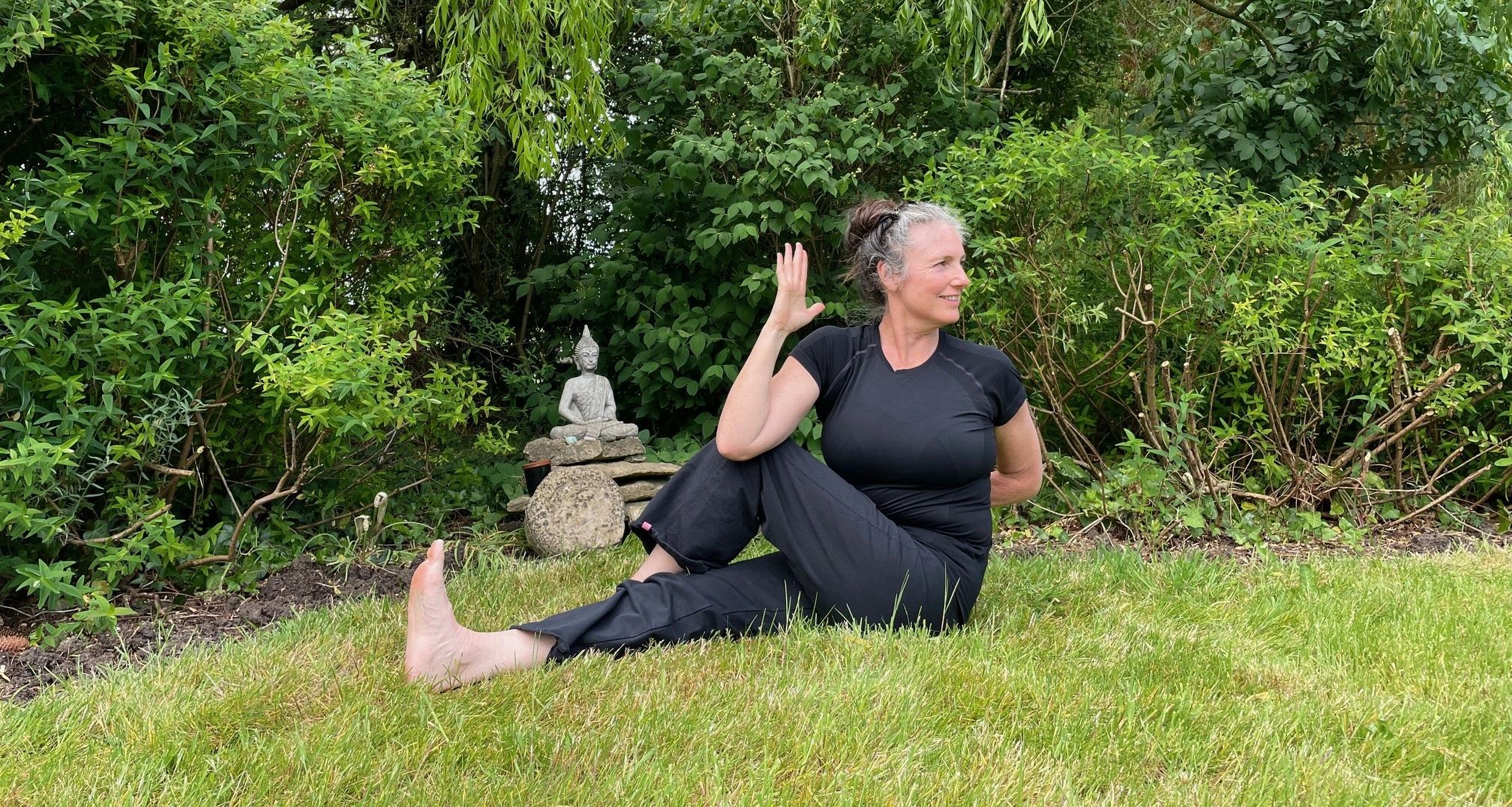 Adele Robertson in seated twist in garden