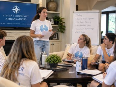 Students engaged in a community ambassador meeting.