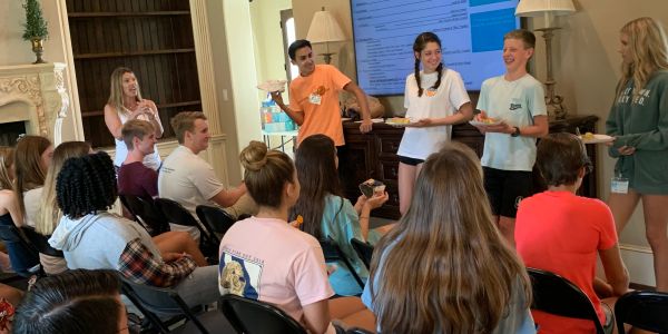 Group of young people engaged in a presentation or meeting.