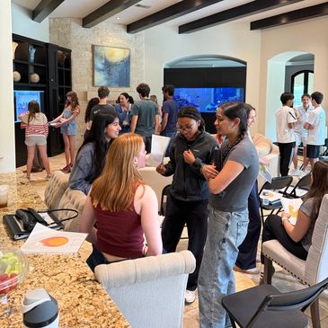 Group of people socializing indoors at a casual gathering.