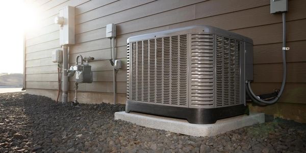 Air conditioning unit installed on a home, ensuring efficient cooling and energy savings for HVAC.