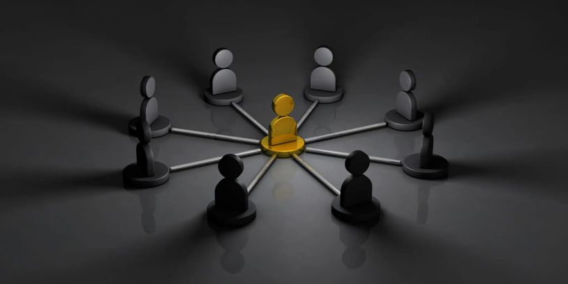 A golden figure connected to eight black figures, symbolizing leadership or centrality.