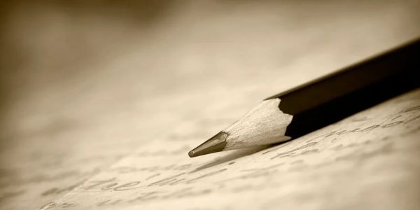Pencil resting on handwritten note, symbolizing clarity, purpose, and intentional work of purpose