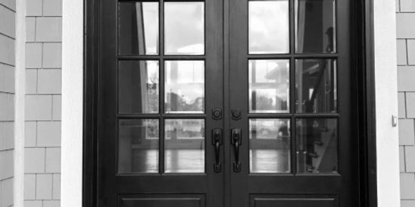 Double doors with glass opening to natural light, symbolizing connection, openness, and direction