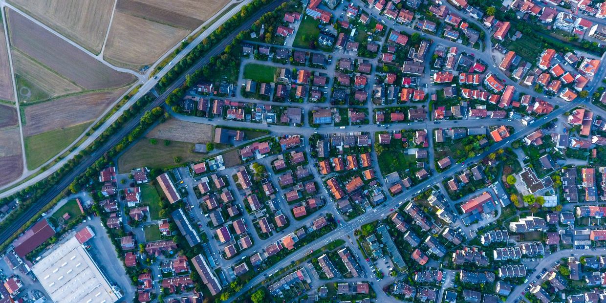 Aerial view of a residential area with houses and roads.