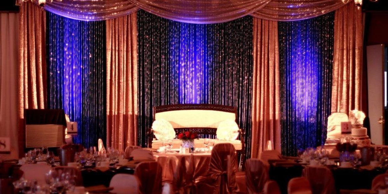 Elegant event stage with golden and blue lighting.