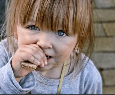 Child eating a cookie.