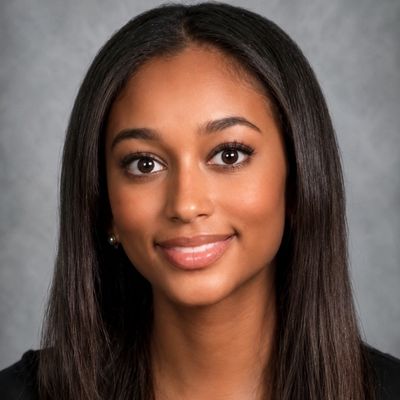 Professional headshot of a young woman with long straight hair and a warm smile.