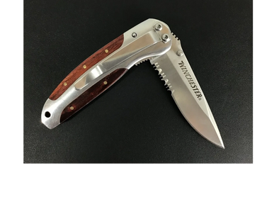 Winchester folding pocket knife with wooden and metal handle.
