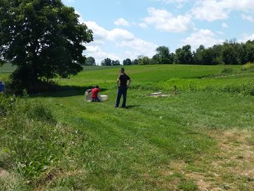 firearms instructor teaching a youth, teenager or adult how to shoot with a rifle, pistol, shotgun