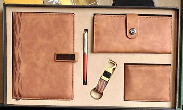 Leather gift set with notebook, pen, wallet, cardholder, and keychain.