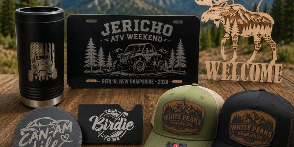 Engraved outdoor-themed merchandise including hats, signs, and mugs.