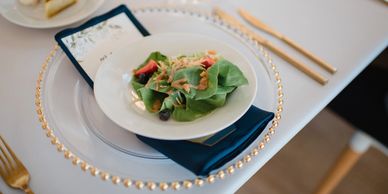 Elegant salad on a decorated plate with chopsticks.