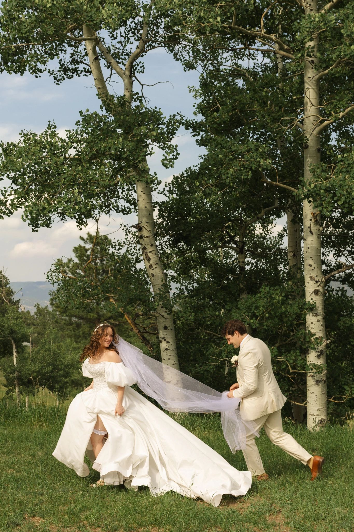Bride and groom playful moment outdoors.
