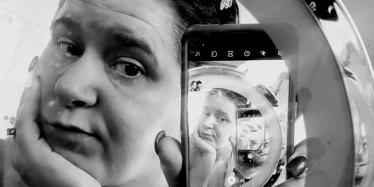 Picture of Tamara Collins looking into a phone