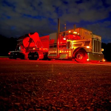 Sandell Transport truck number 014 at night with lights on
