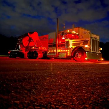 Sandell Transport truck number 014 at night with lights on