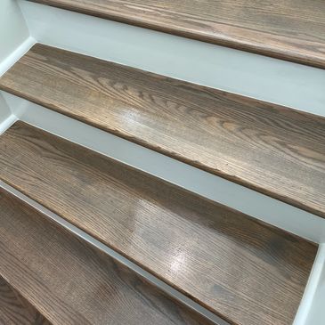 Wooden stairs with white risers.