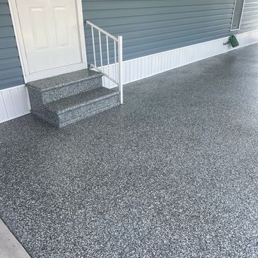 Smooth epoxy coated floor with stairs and blue wall.