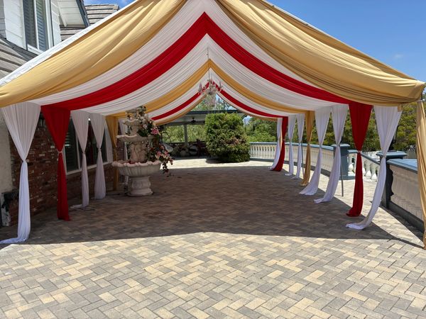20x30 Canopy with Red and Gold Draping and Chandelier. 
