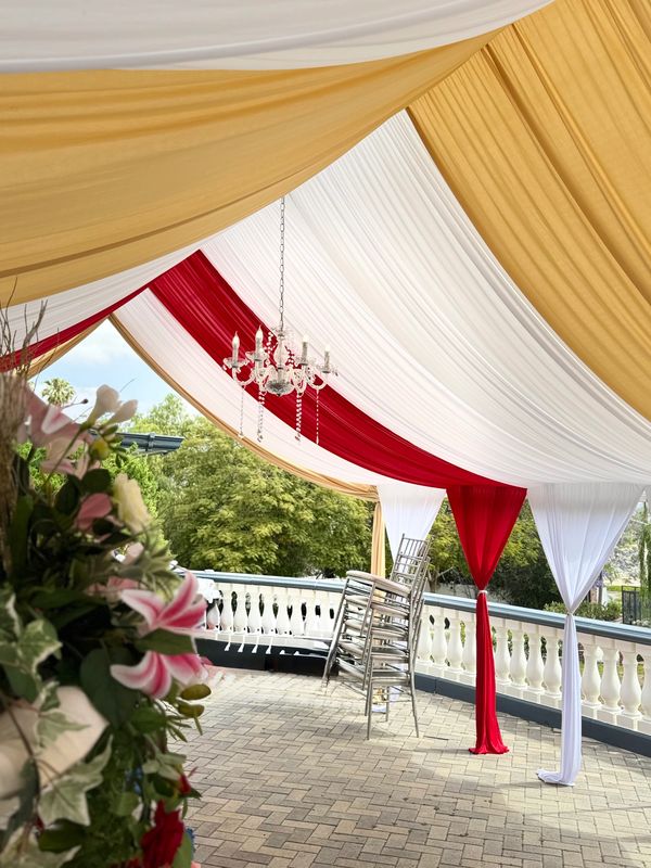 20x30 Canopy with Red and Gold Draping and Chandelier. 